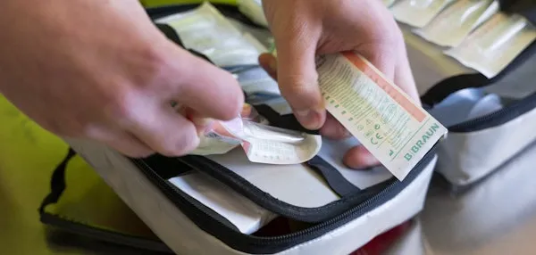 Close-up of hands sorting medical material.