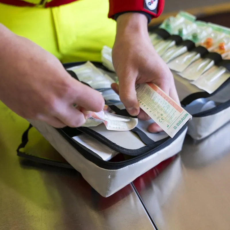 Close-up of hands sorting medical material.