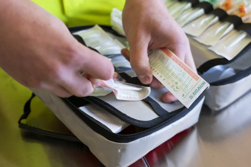 Close-up of hands sorting medical material.