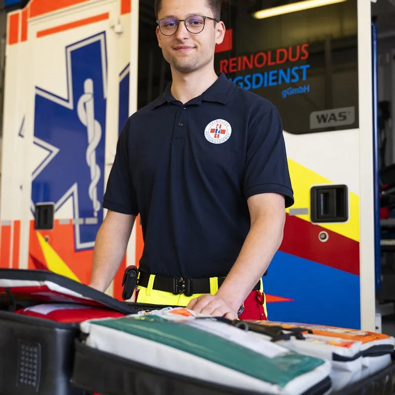 Man standing in front of an ambulance