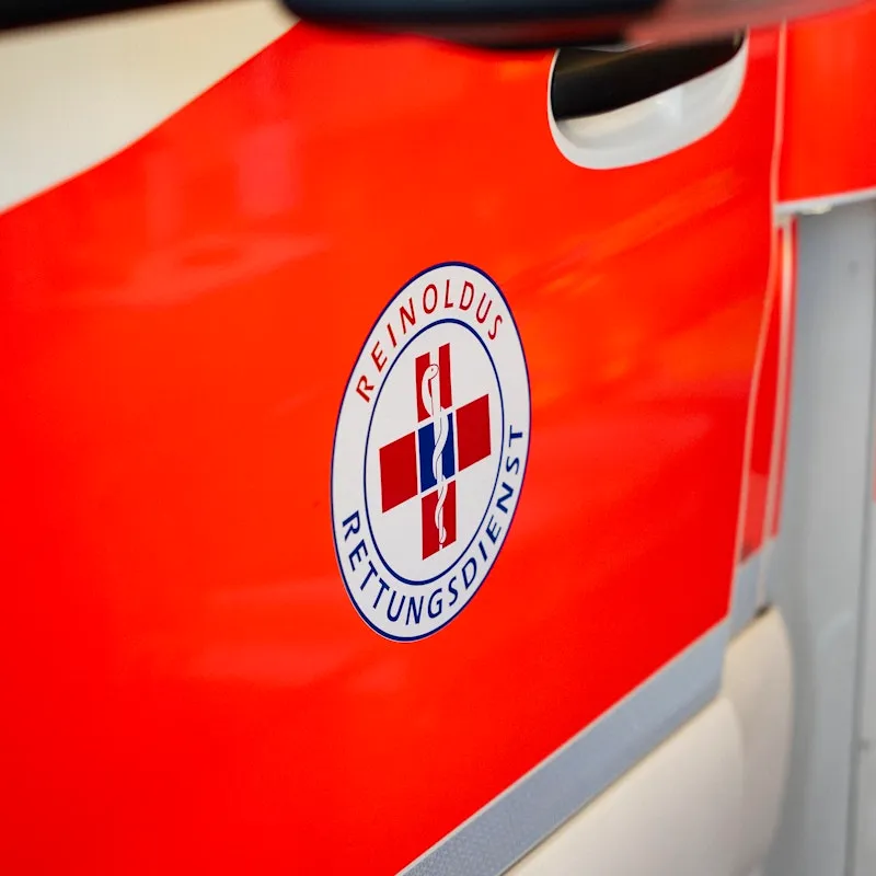 Close-up of an ambulance showing the logo of the organisation.