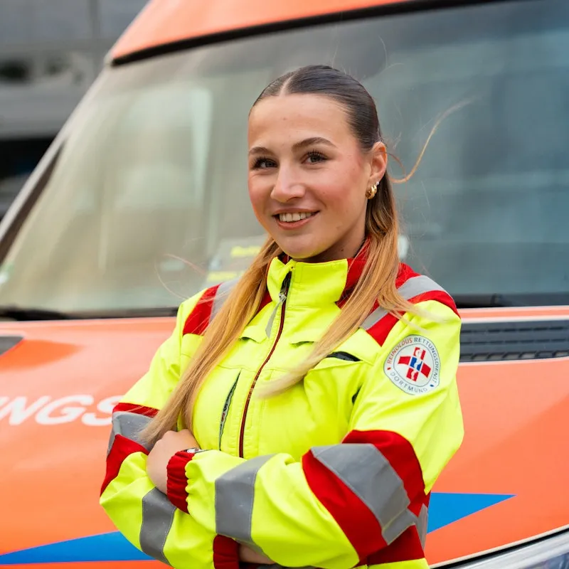 Woman standing in front of an ambulance