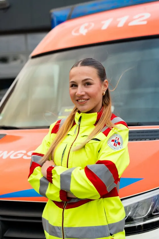 Woman standing in front of an ambulance